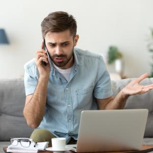 Frustrated man talking on phone trying to get a response