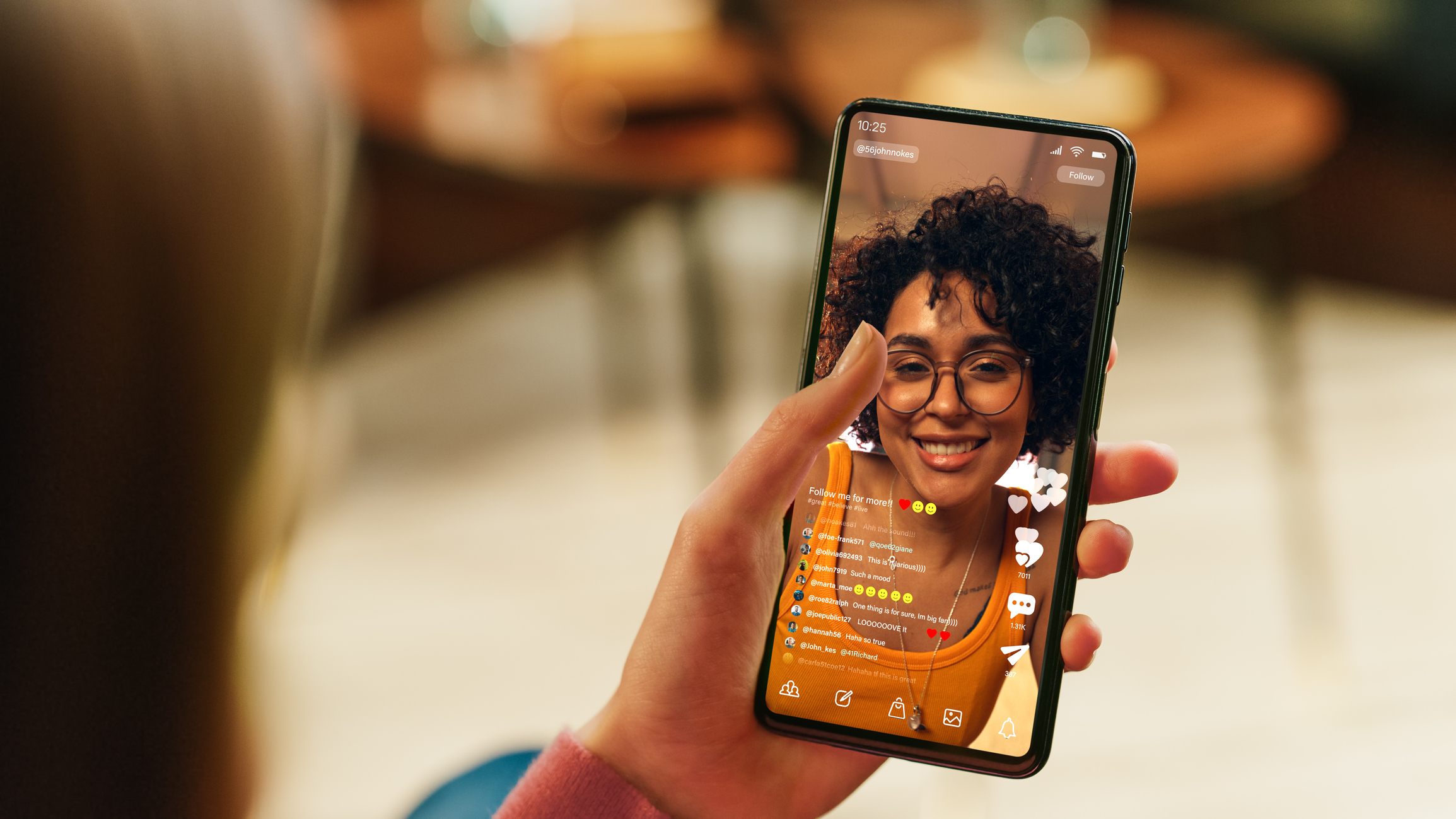 Feminine Hand Holding a Smartphone with Social Media Application on Display.