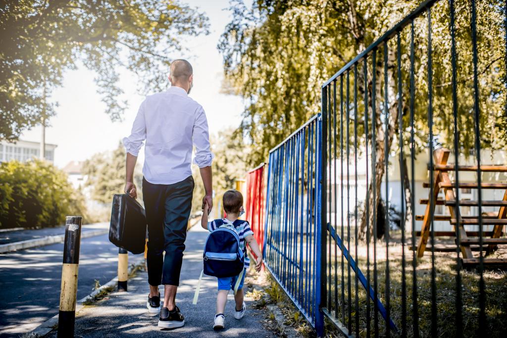 Father and son walking to school.