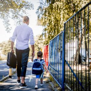 Father and son walking to school.