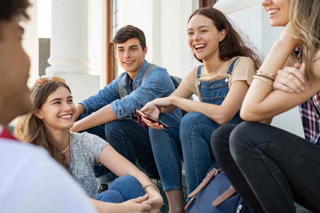 Group of happy young friends sitting and talking.