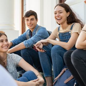 Group of happy young friends sitting and talking.
