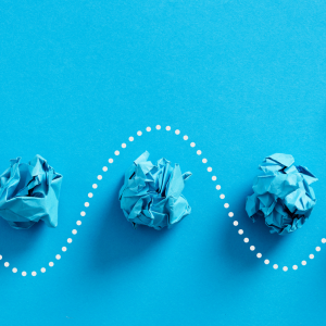 Paper plane passes through the crumpled paper balls.