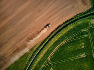 Tractor farming field drone shot for a farming businesses