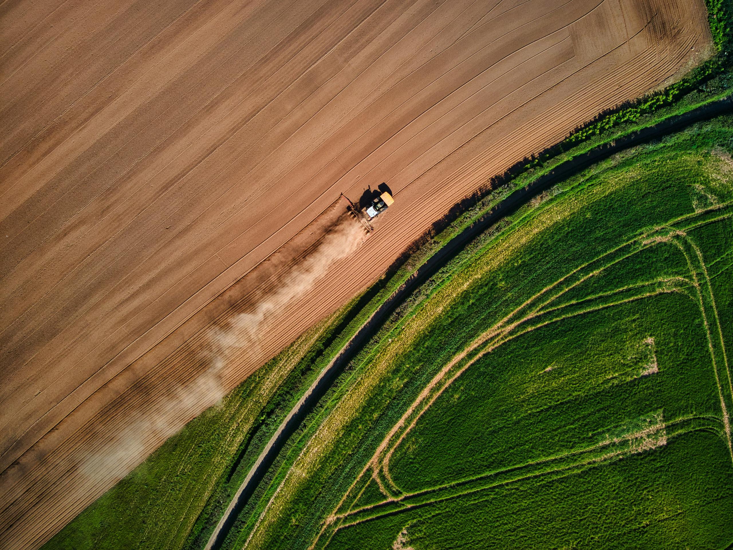 Tractor farming field drone shot for a farming businesses