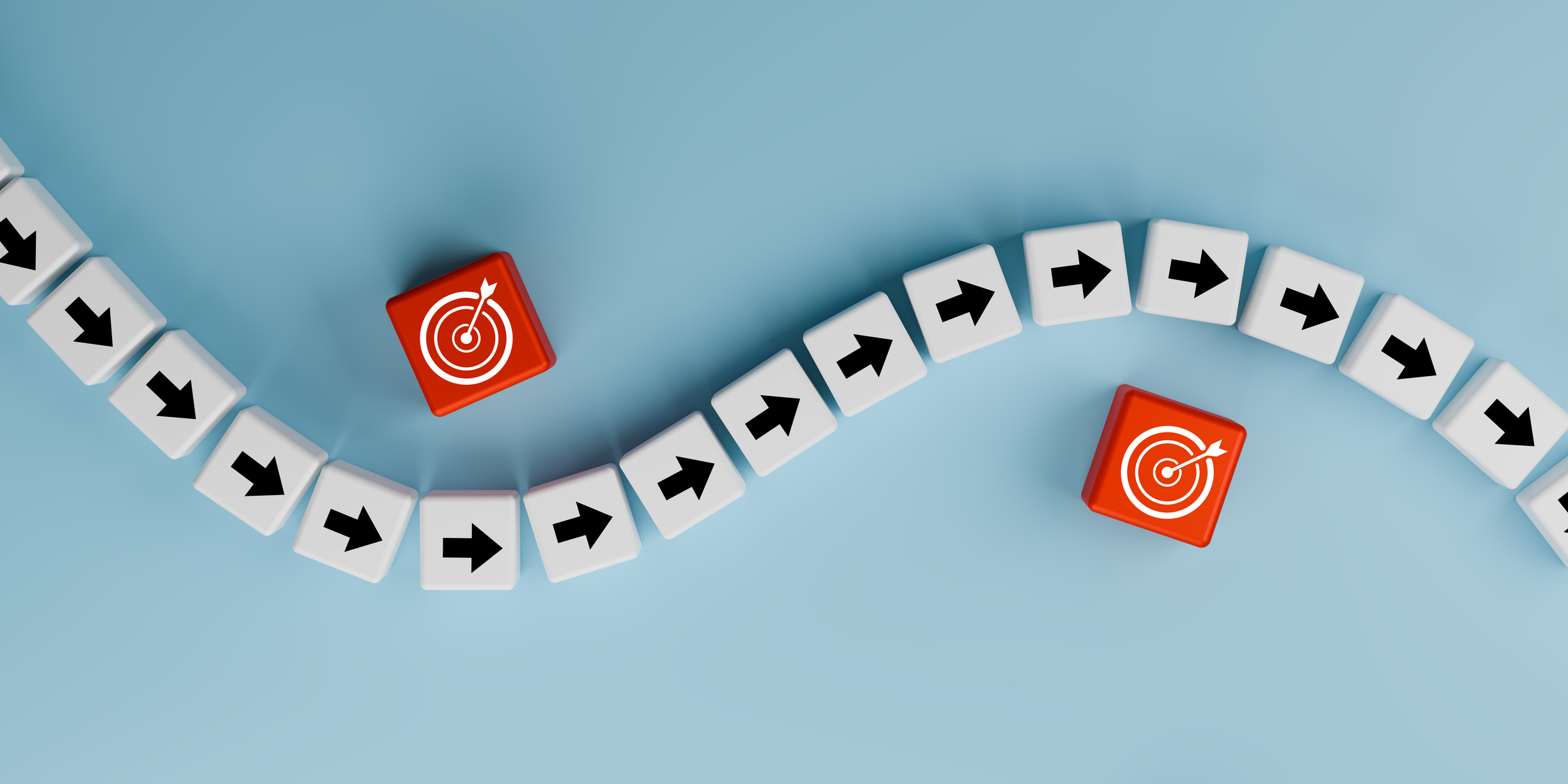 Concept of a roadmap showing directional tiles for movement and bullseyes for goals achieved