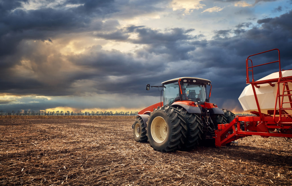 A powerful tractor works in the field Stephens Scown